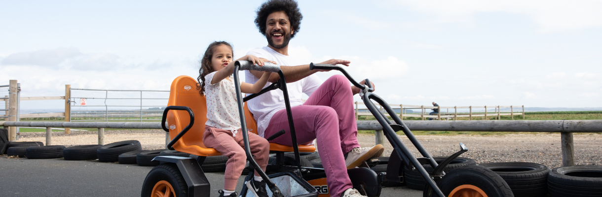 Father and daughter on the go karts at Tapnell Farm on the Isle of Wight