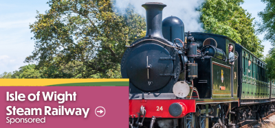 Train travelling along the tracks at Isle of Wight Steam Railway on the Isle of Wight