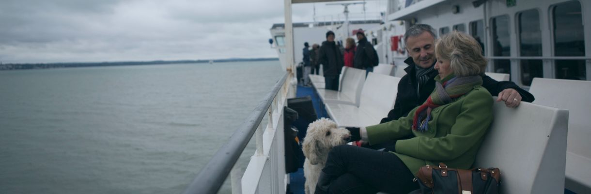 Couple sitting on the Wightlink ferry with their dog